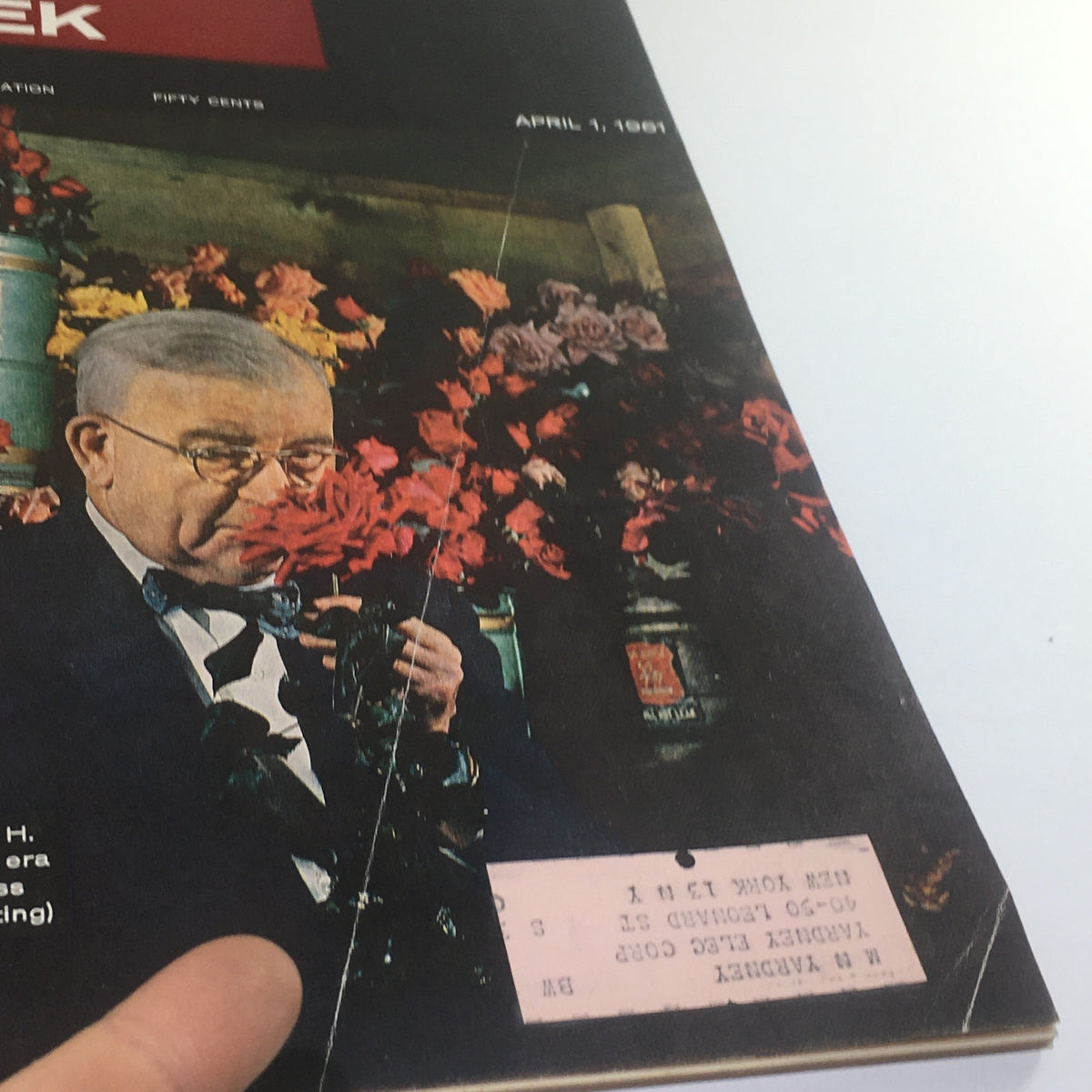 Close-up of the cover of Business Week Magazine from April 1, 1961, showcasing Charles H. Perkins with roses, emphasizing the theme of mass production in the floral industry.