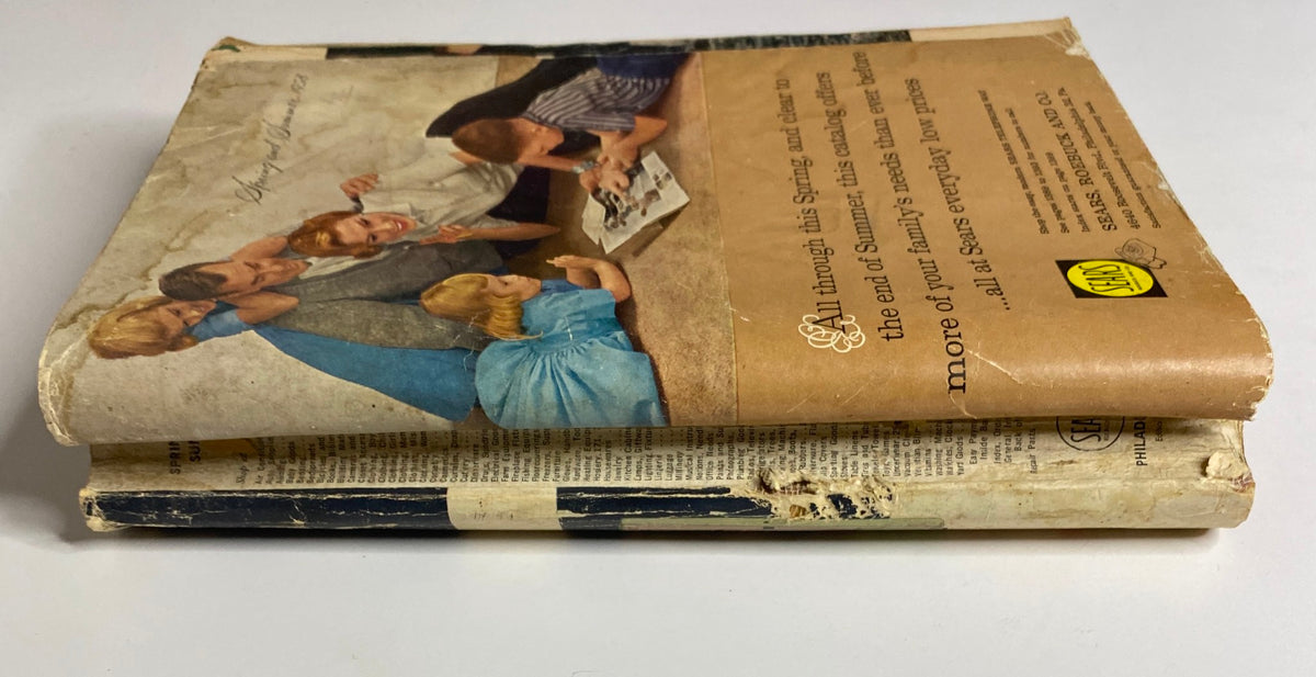 Side view of the 1958 Sears, Roebuck and Co. Spring and Summer Catalog, showing the spine and back cover with a family's engagement with the catalog.