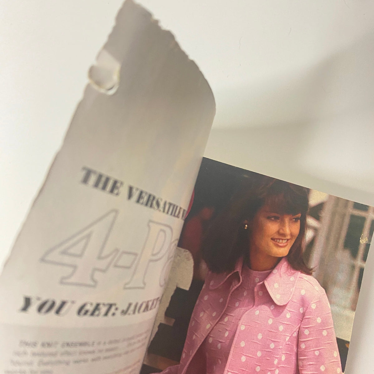 An interior page from the 1975 Montgomery Ward Spring and Summer Catalog displaying a 4-piece versatile outfit with a model wearing a pink dotted jacket and smiling.