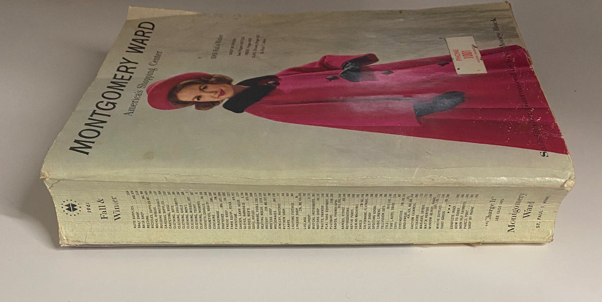 Side view of the 1961 Montgomery Ward Fall and Winter Catalog showing its thickness and vintage style, highlighting its historical significance in American retail.
