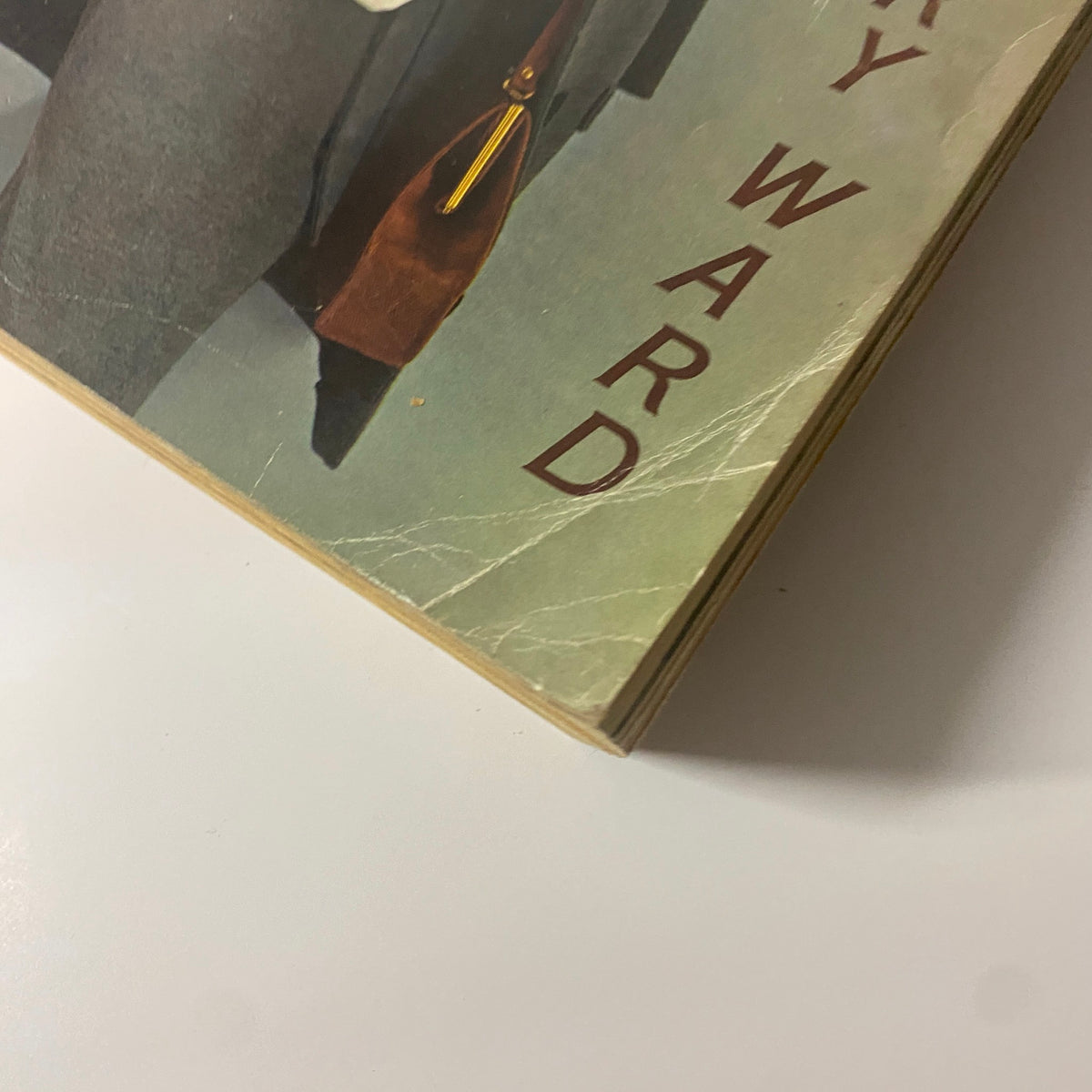 Close-up of the corner of the 1962 Montgomery Ward Fall and Winter Catalog, emphasizing the vintage design and branding of Montgomery Ward.