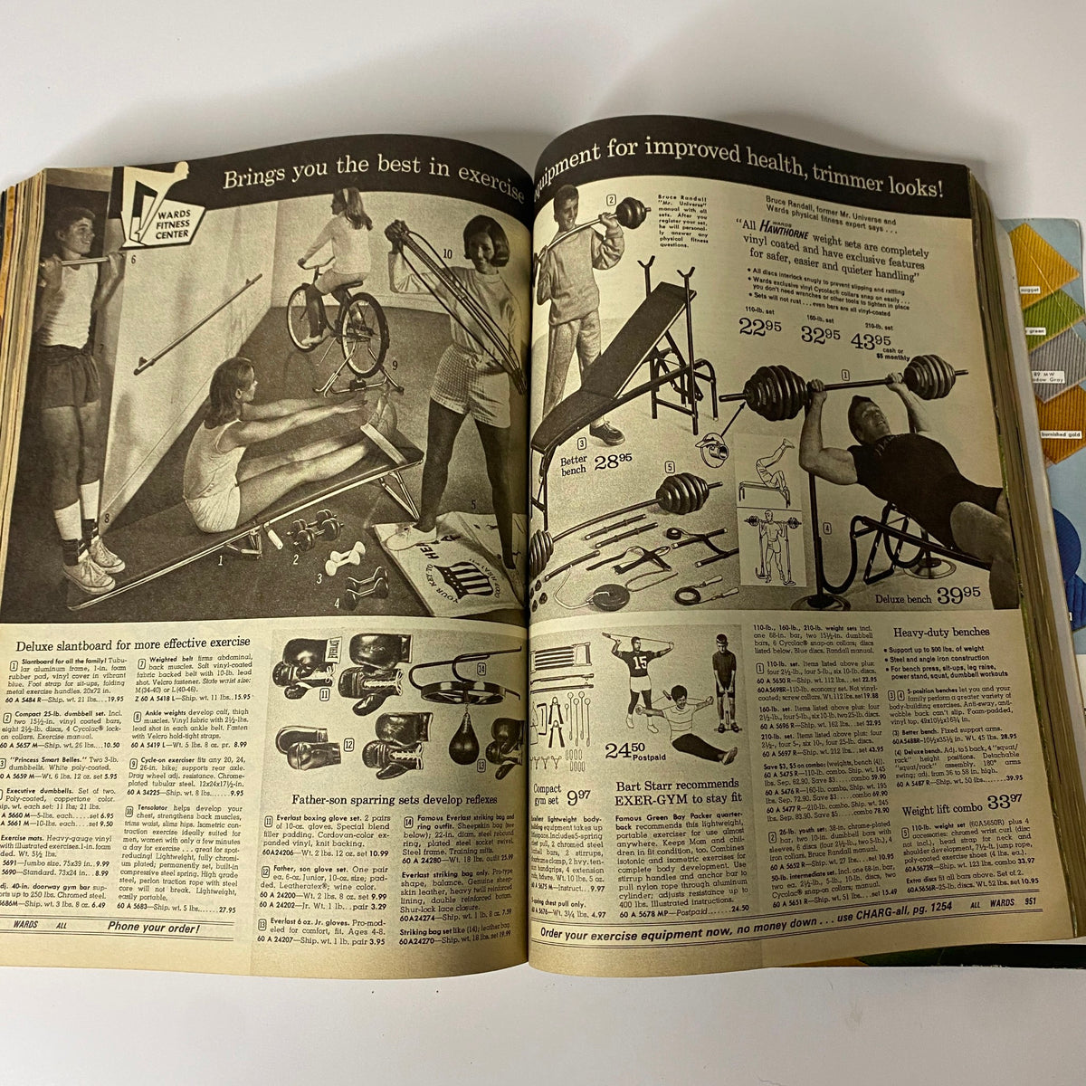 1970 Montgomery Ward Spring and Summer Catalog displaying exercise equipment, such as weights and benches, emphasizing fitness trends popular during the 1970s.