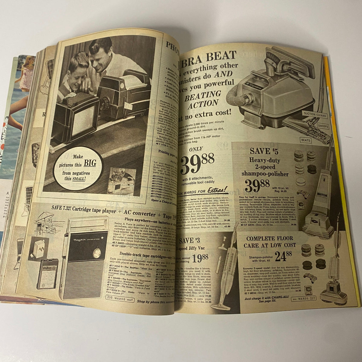 1968 Montgomery Ward Summer Catalog with advertisements for household appliances including a cartridge tape player and shampoo-polisher, typical of mid-century American homes.