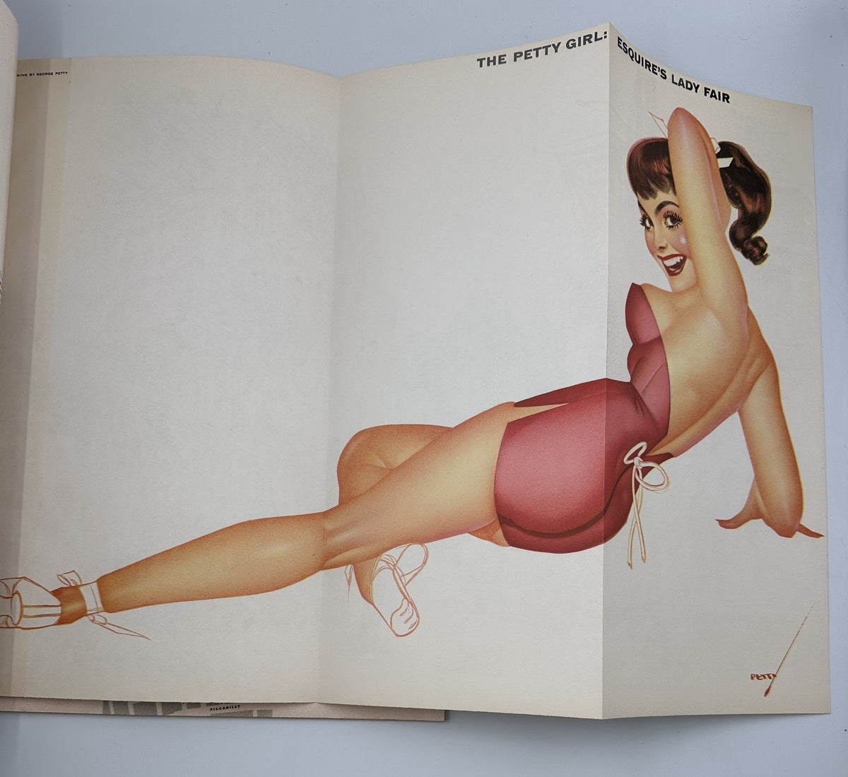 Foldout page in Esquire Magazine April 1955 showcasing the Petty Girl pinup art by George Petty, celebrating mid-20th century aesthetics.