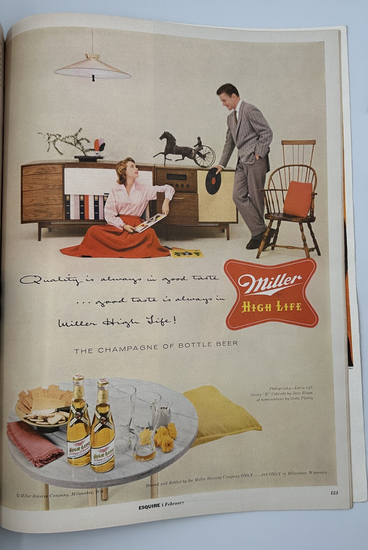 Vintage advertisement from Esquire Magazine February 1956 featuring a stylish couple enjoying Miller High Life beer, showcasing elegance and leisure in a retro setting.