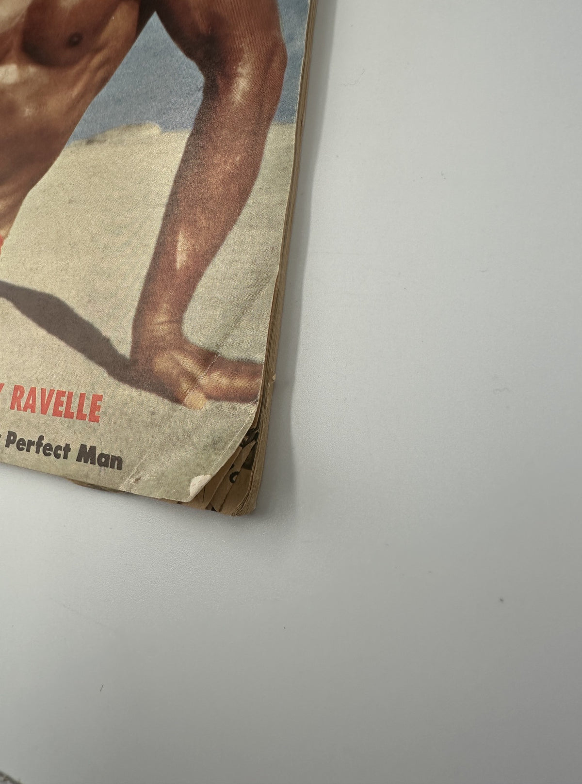 Close-up of the edge of the Muscle Power Magazine July 1954, showing the worn condition, reflecting its vintage status and collectible value.