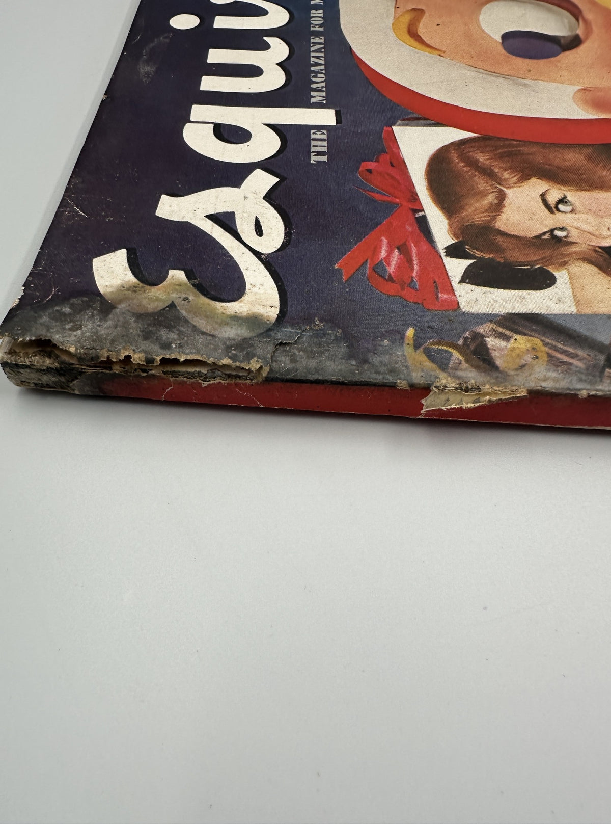Close-up of the spine of Esquire Magazine December 1950, illustrating the magazine's aged wear and detailing the festive cover art.