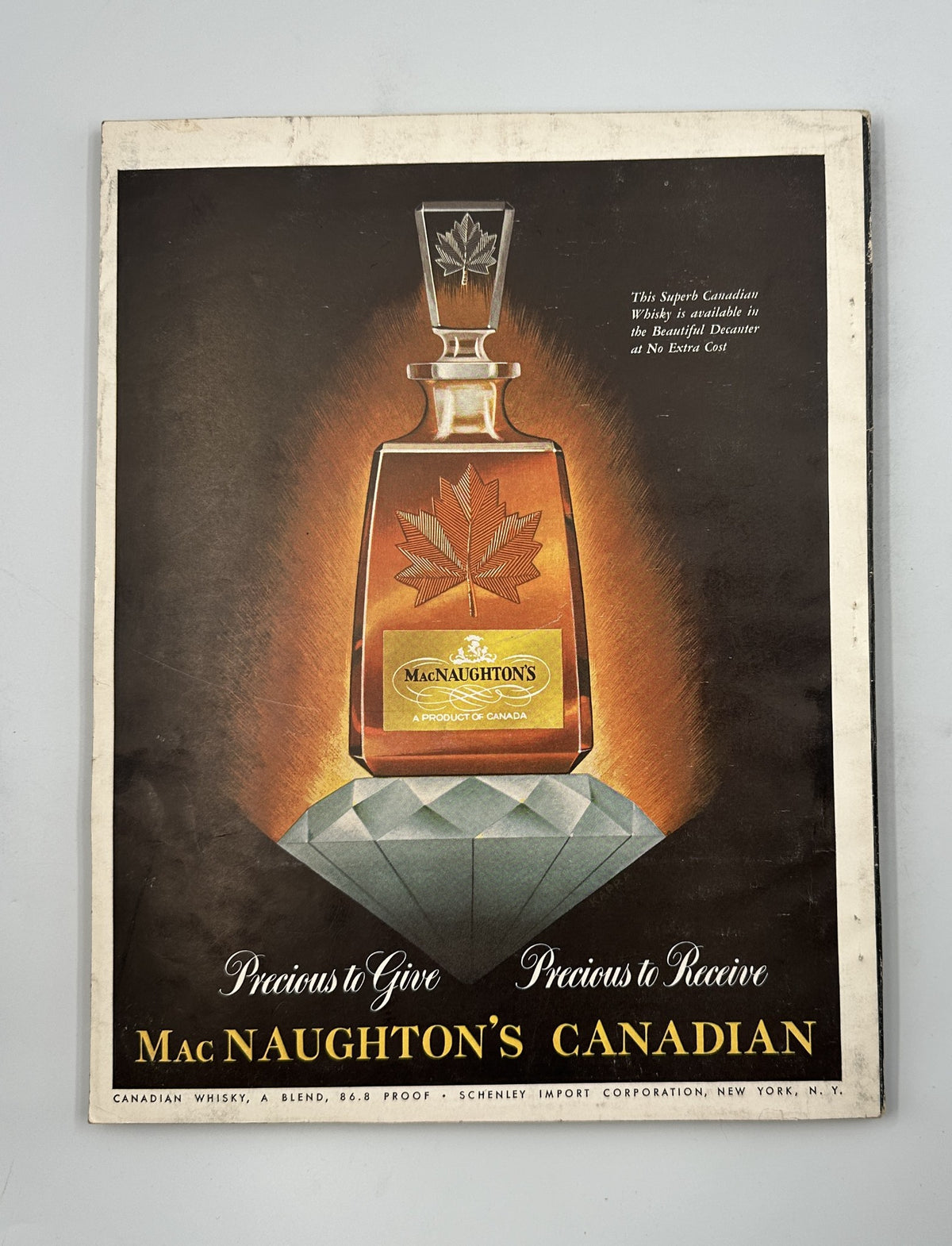 Advertisement for Mac Naughton’s Canadian whisky from December 1954 Esquire Magazine, emphasizing its premium quality and design.