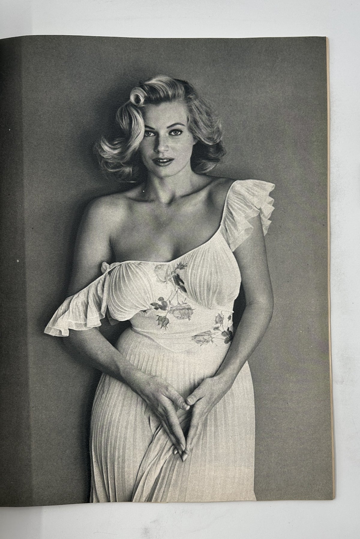 Esquire Magazine November 1954 presents a striking black-and-white photo of a blonde model wearing an elegant dress with ruffled details, embodying classic beauty.