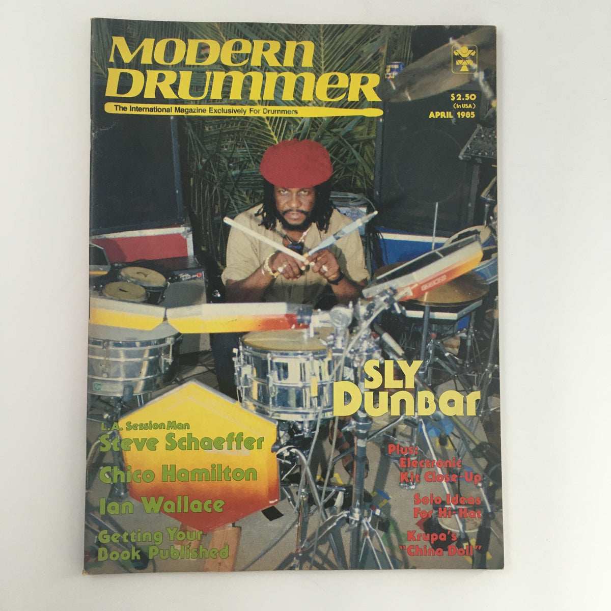 Cover of Modern Drummer Magazine April 1985 featuring drummer Sly Dunbar. The magazine showcases interviews with notable drummers including Steve Schaeffer and Chico Hamilton, emphasizing the vibrant drumming culture of the mid-80s.
