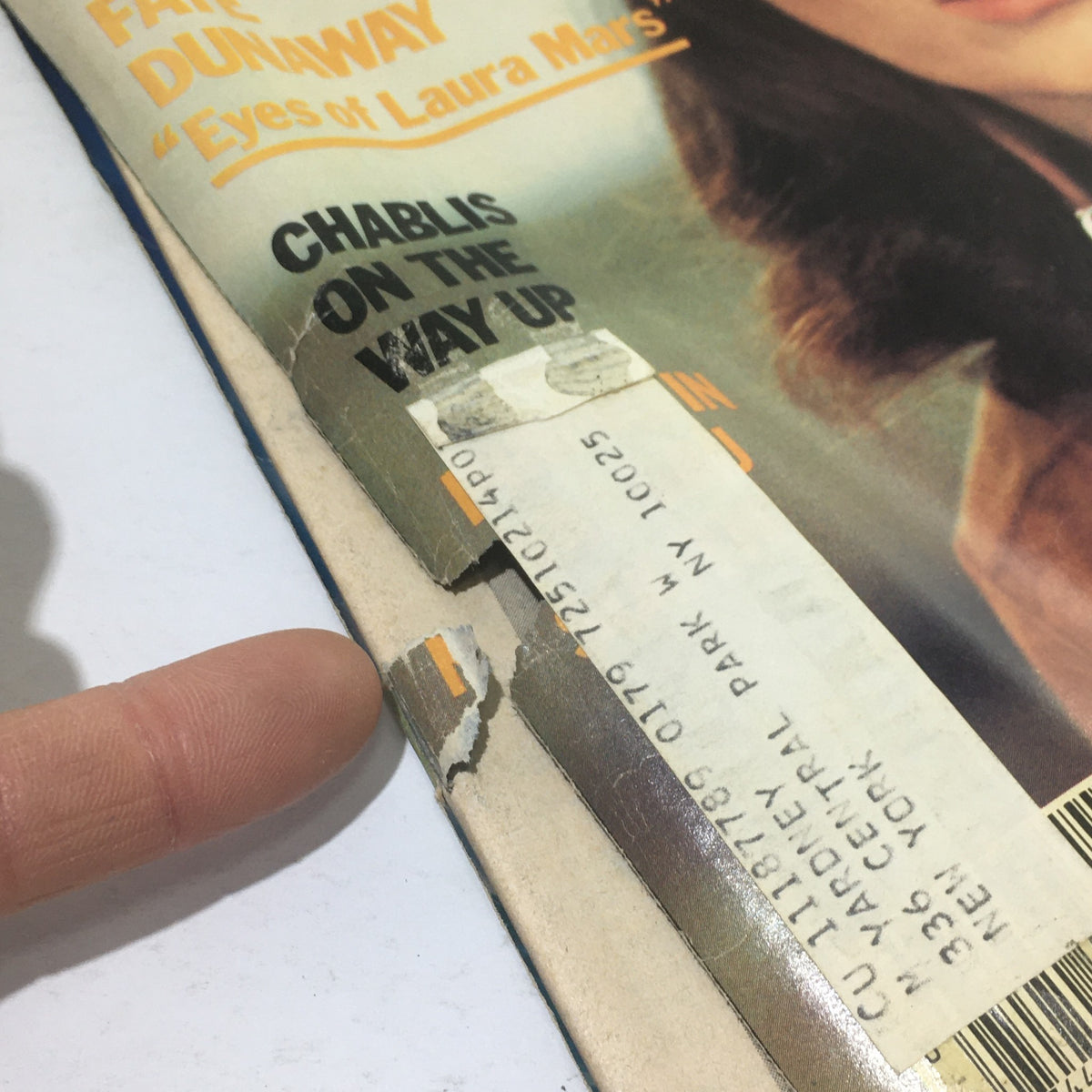Detailed view of the Cue Magazine cover from July 21, 1978, highlighting a damaged edge and address label for Faye Dunaway's issue, 'Eyes of Laura Mars'.