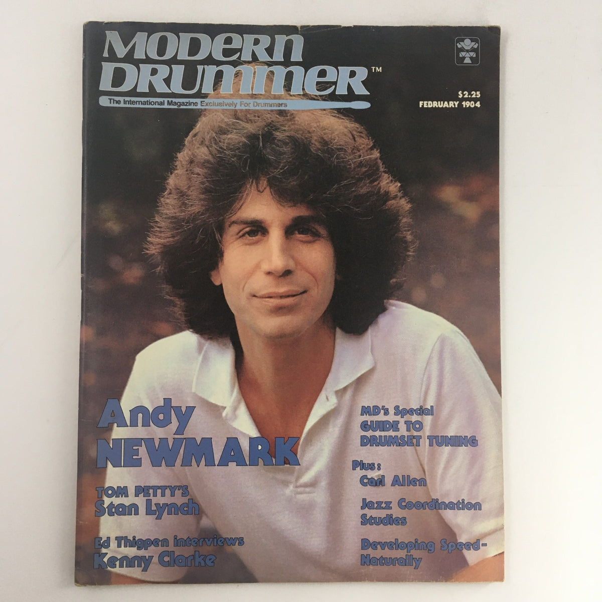 Cover of Modern Drummer Magazine, February 1984 featuring Andy Newmark, with mentions of Tom Petty's Stan Lynch and an interview with Kenny Clarke. The cover highlights drumming techniques and tips.
