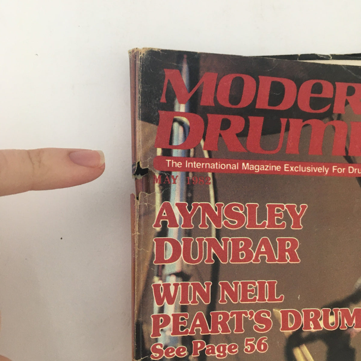 Close-up of the spine of Modern Drummer Magazine May 1982, showcasing the title and partial contents including Aynsley Dunbar and Neil Peart's drums.