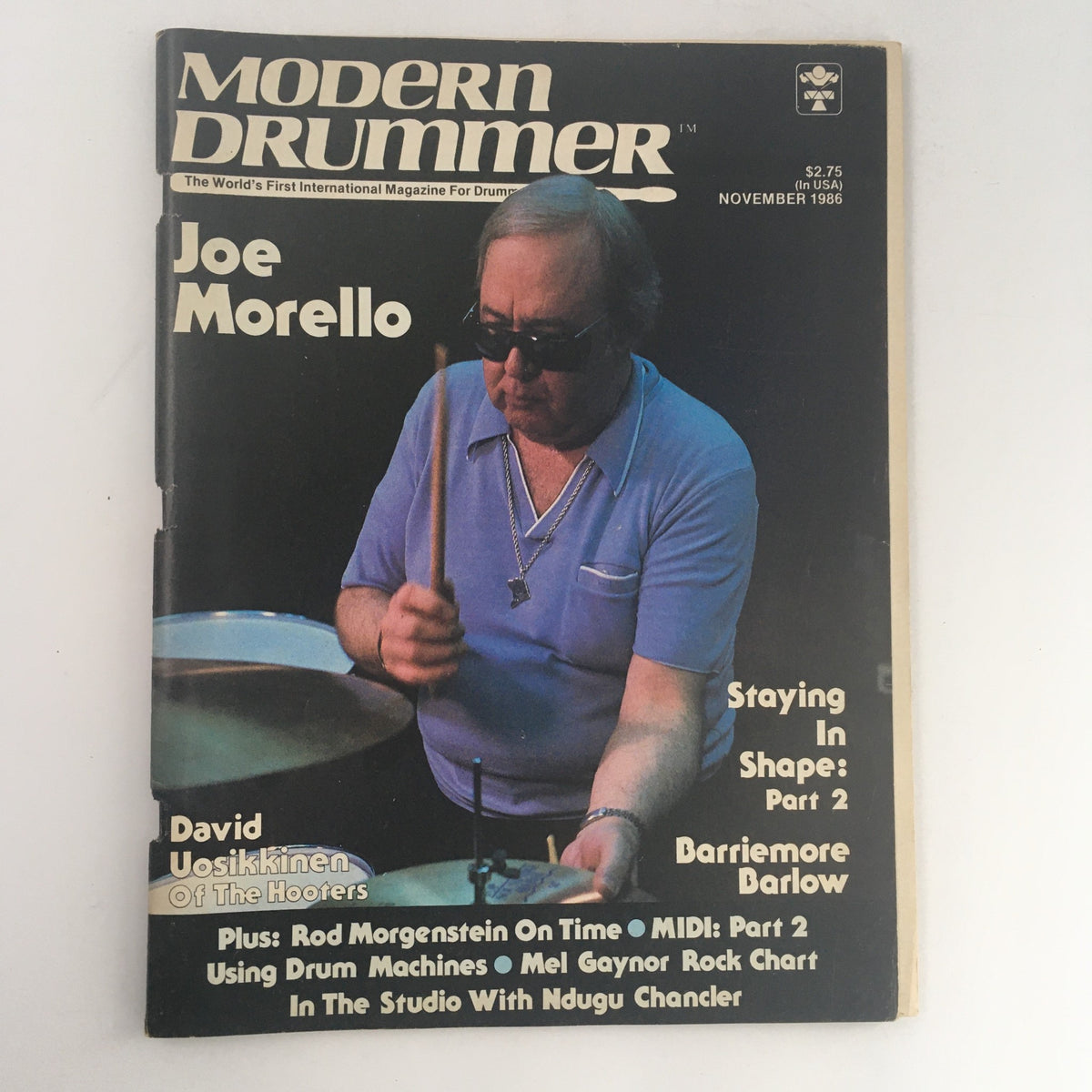 Cover of Modern Drummer Magazine November 1986 featuring Joe Morello playing drums, highlighting featured articles and other drummers including David Uosikkinen and Mel Gaynor.