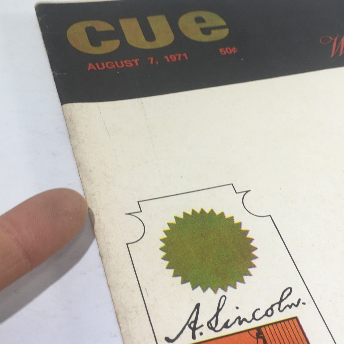 Close-up view of Cue Magazine: August 1 1971 cover showcasing A. Lincoln emblem and green star.