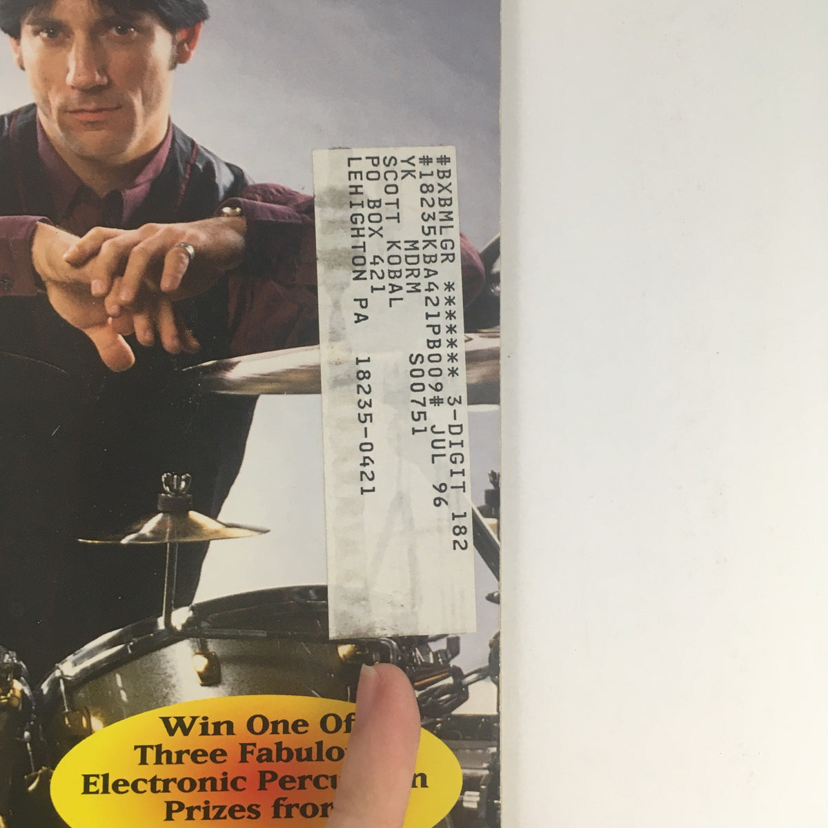 Close-up of the side of Modern Drummer Magazine May 1996 featuring promotional details and the presence of the address label. The magazine features Jimmy Chamberlin, Idris Muhammad, and Tom Roady.