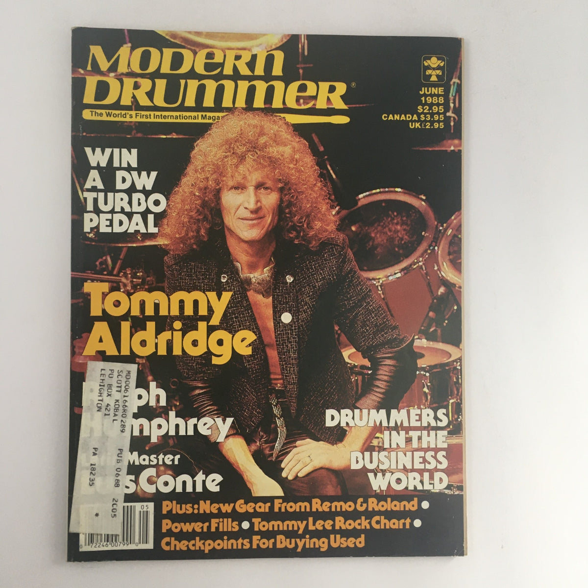 Modern Drummer Magazine June 1988 featuring Tommy Aldridge on the cover, showcasing his iconic curly hair and a vibrant drum set background. This vintage magazine highlights influential drummers of the late 1980s.