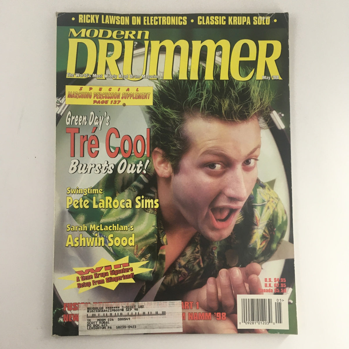 Cover of Modern Drummer Magazine May 1998 featuring Tre Cool bursting out, along with drummers Pete LaRoca and Ashwin Sood. The vibrant magazine highlights iconic moments in drumming and music culture.