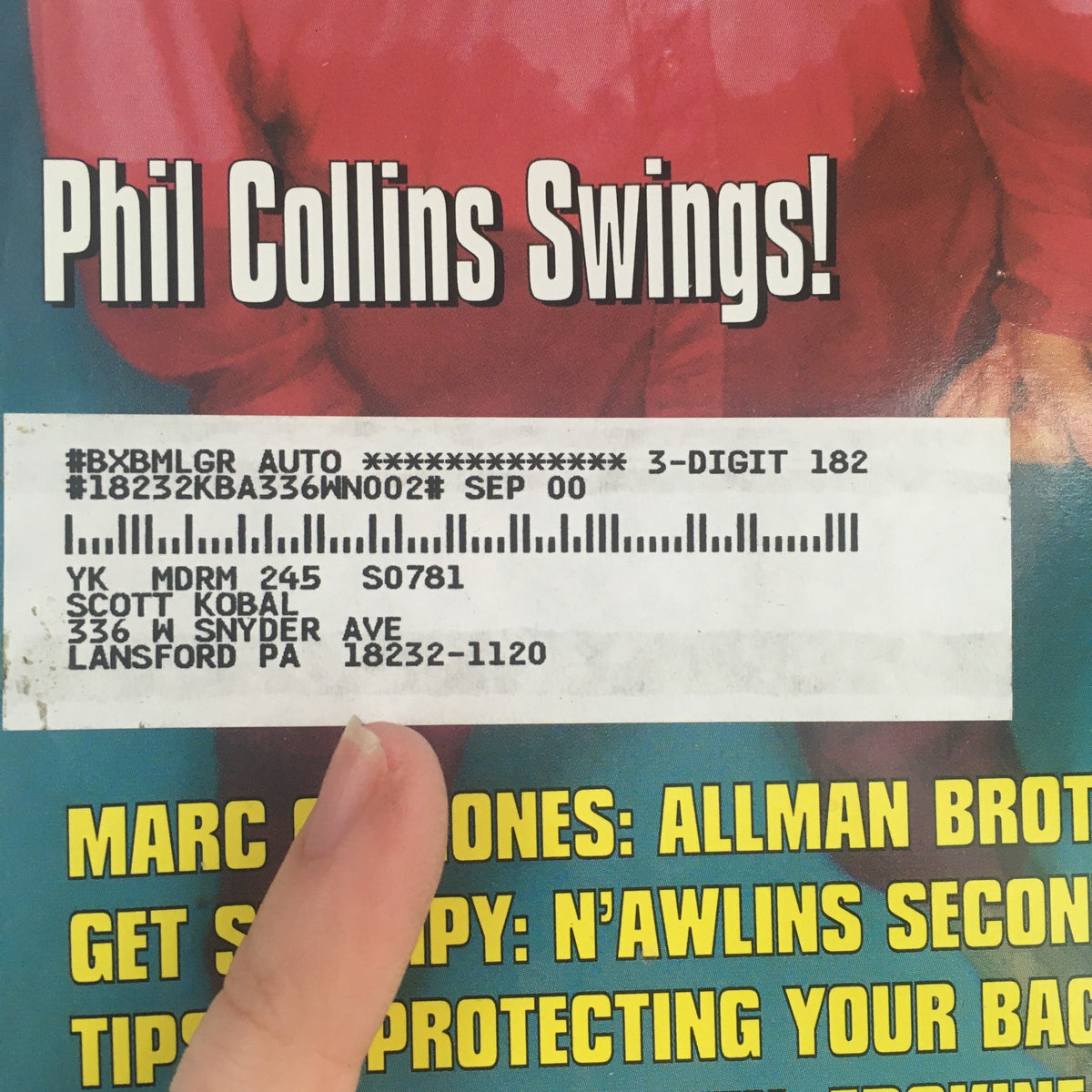 Close-up of the cover of Modern Drummer Magazine, December 1999, showing the text 'Phil Collins Swings!' and details of the magazine's address.