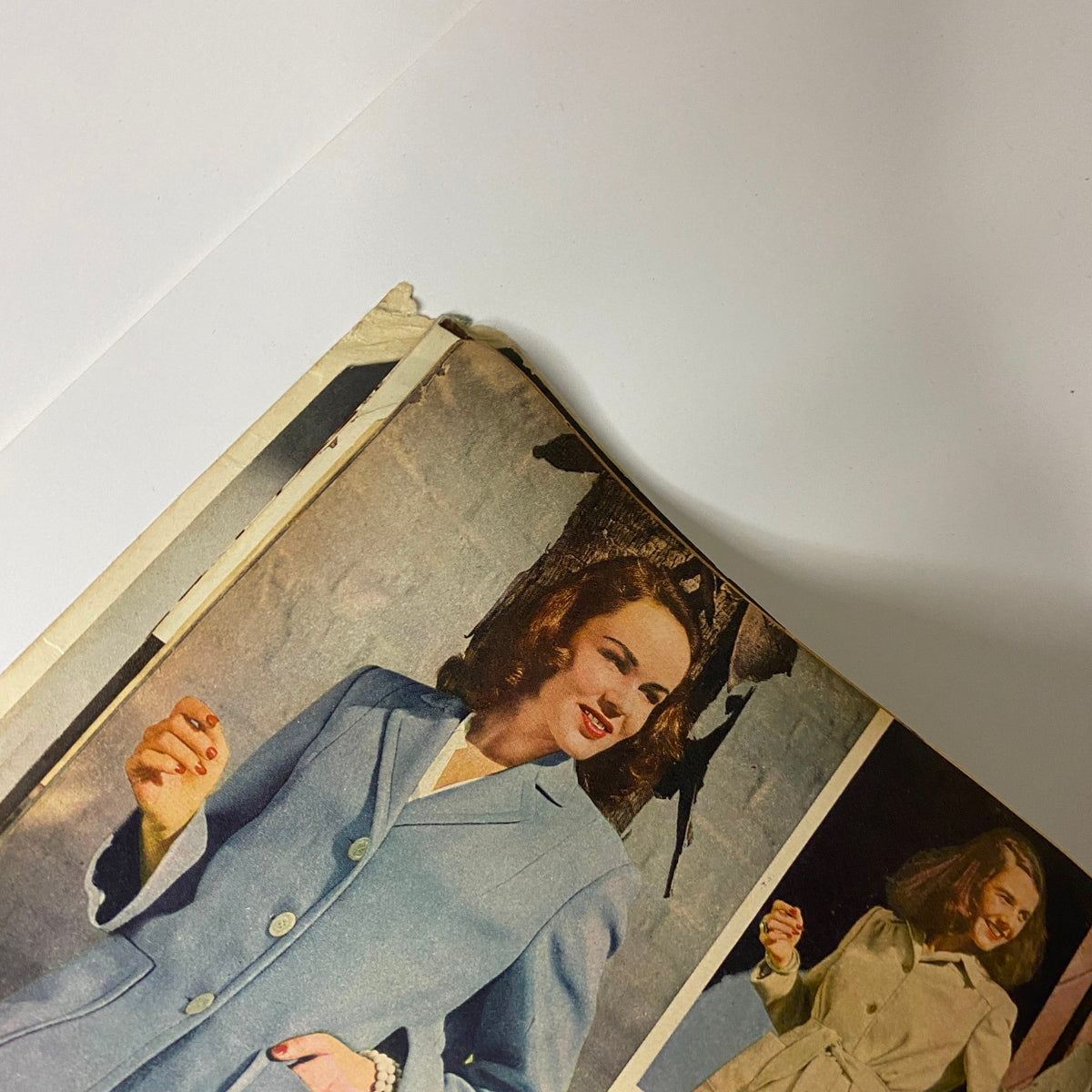 Close-up of a model in the 1942 Montgomery Ward Spring and Summer Catalog, showcasing a stylish light blue coat and elegant hairstyle.