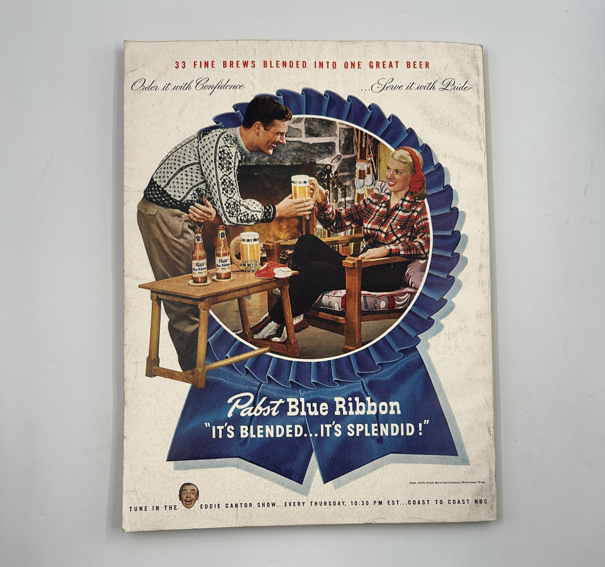 Esquire Magazine January 1947 cover featuring a vintage advertisement for Pabst Blue Ribbon beer, showcasing a man and woman enjoying drinks in a cozy setting, highlighting the magazine's holiday issue.