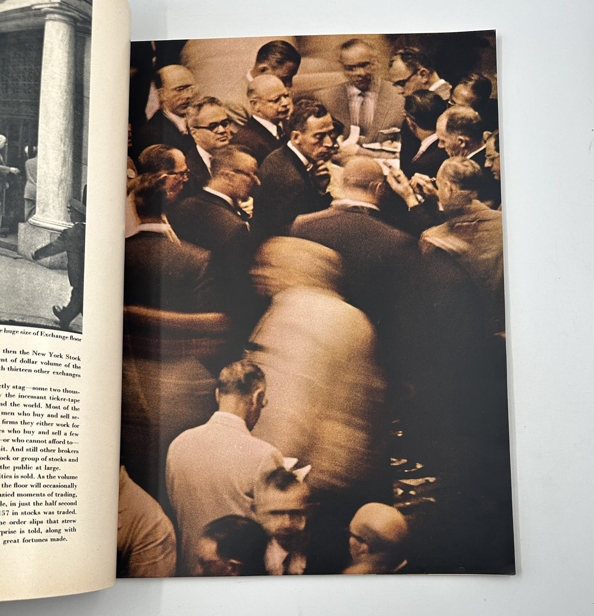 Esquire Magazine November 1957 image depicting a bustling scene at the New York Stock Exchange with a focus on stock traders engaged in transactions.