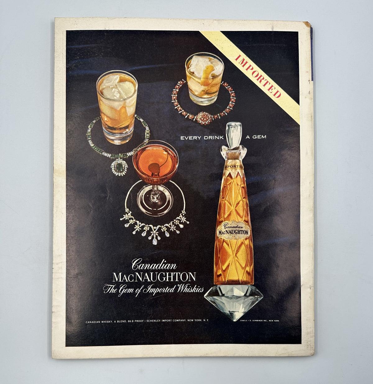 Esquire Magazine November 1957 advertisement for Canadian MacNaughton whisky, featuring elegant cocktails and jewelry, highlighting premium beverage culture.