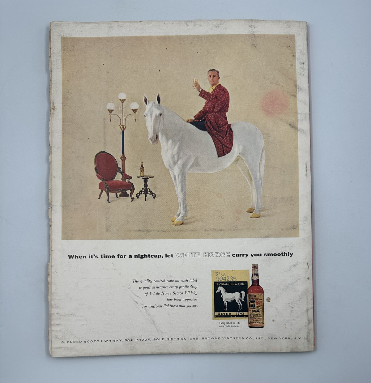 Esquire Magazine January 1957 Jazz Feature Mike Ludlow Esquire Girl Portfolio featuring an advertisement for White Horse Whisky with a man in a robe riding a white horse.