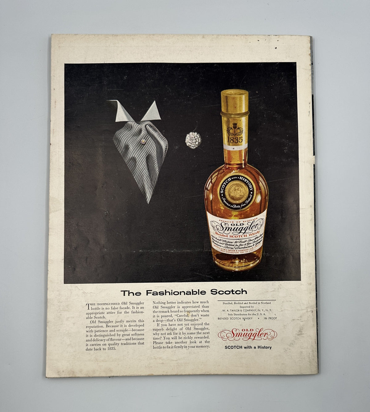 Esquire Magazine January 1958 highlighting Smuggler's Scotch advertisement with a stylish bowtie and diamond, emphasizing the luxurious appeal of the product.