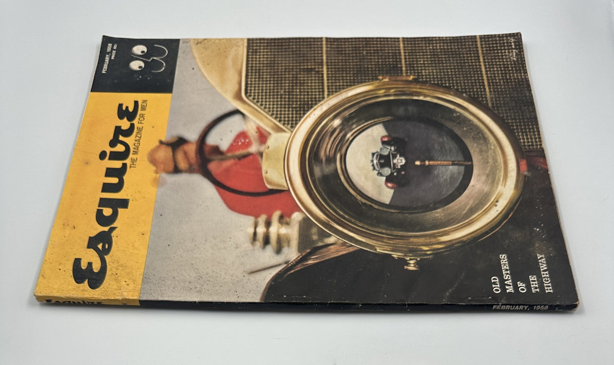 Esquire Magazine February 1958 with a prominent image of a vintage car's headlight, emphasizing the artistic theme 'Old Masters of the Highway'.