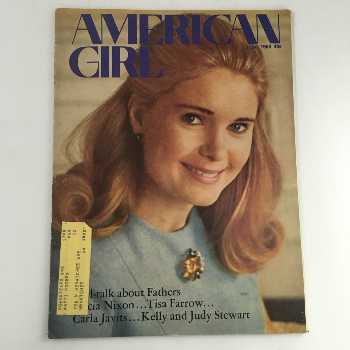 Cover of American Girl Magazine from June 1969 featuring a young woman with blonde hair, dressed in a blue top, highlighting distinguished figures like Tricia Nixon, Tisa Farrow, and Carla Javits in a vintage style.