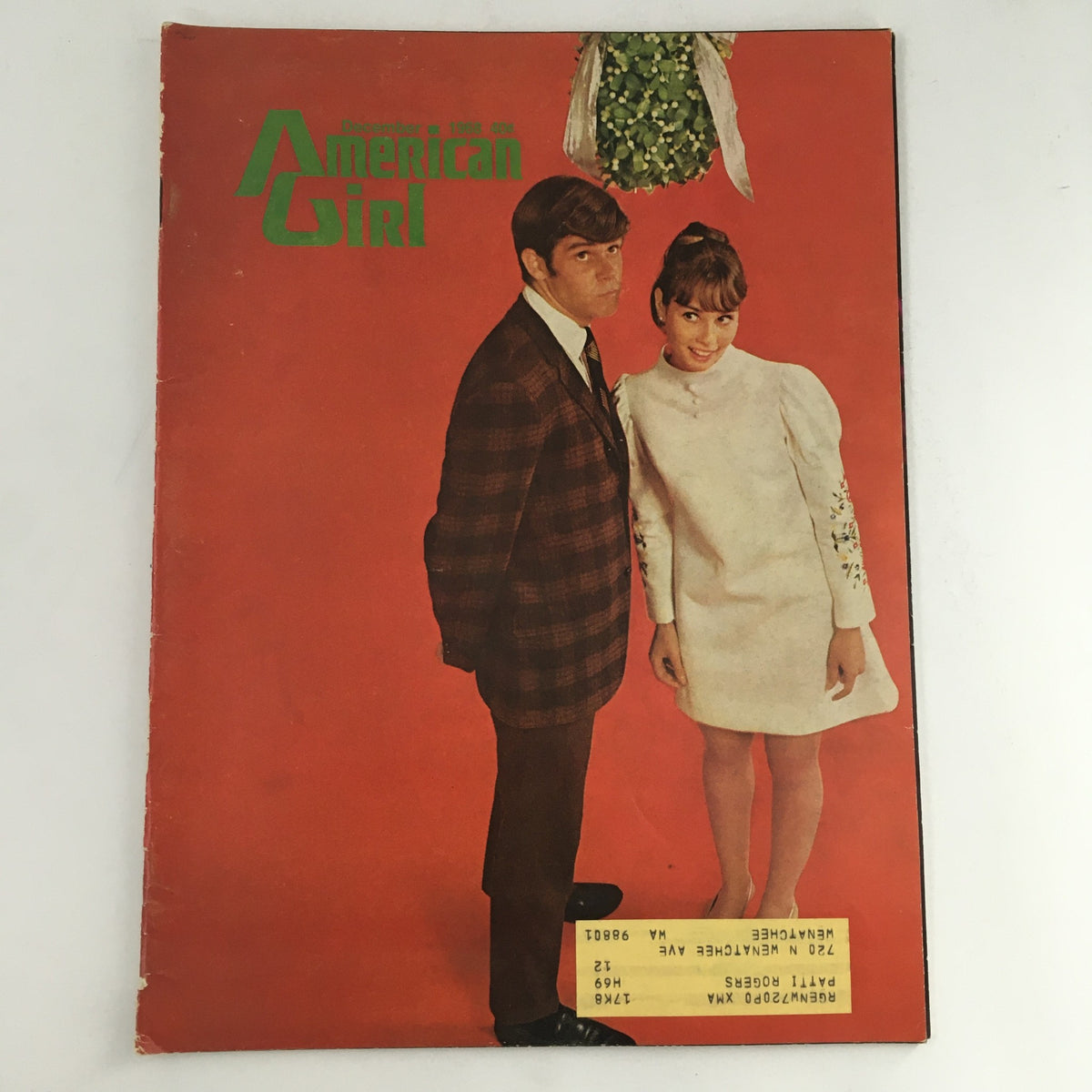 Cover of American Girl Magazine December 1968 featuring vintage teen beauty and fashion lifestyles, showcasing a stylish couple posing against a bright red background.