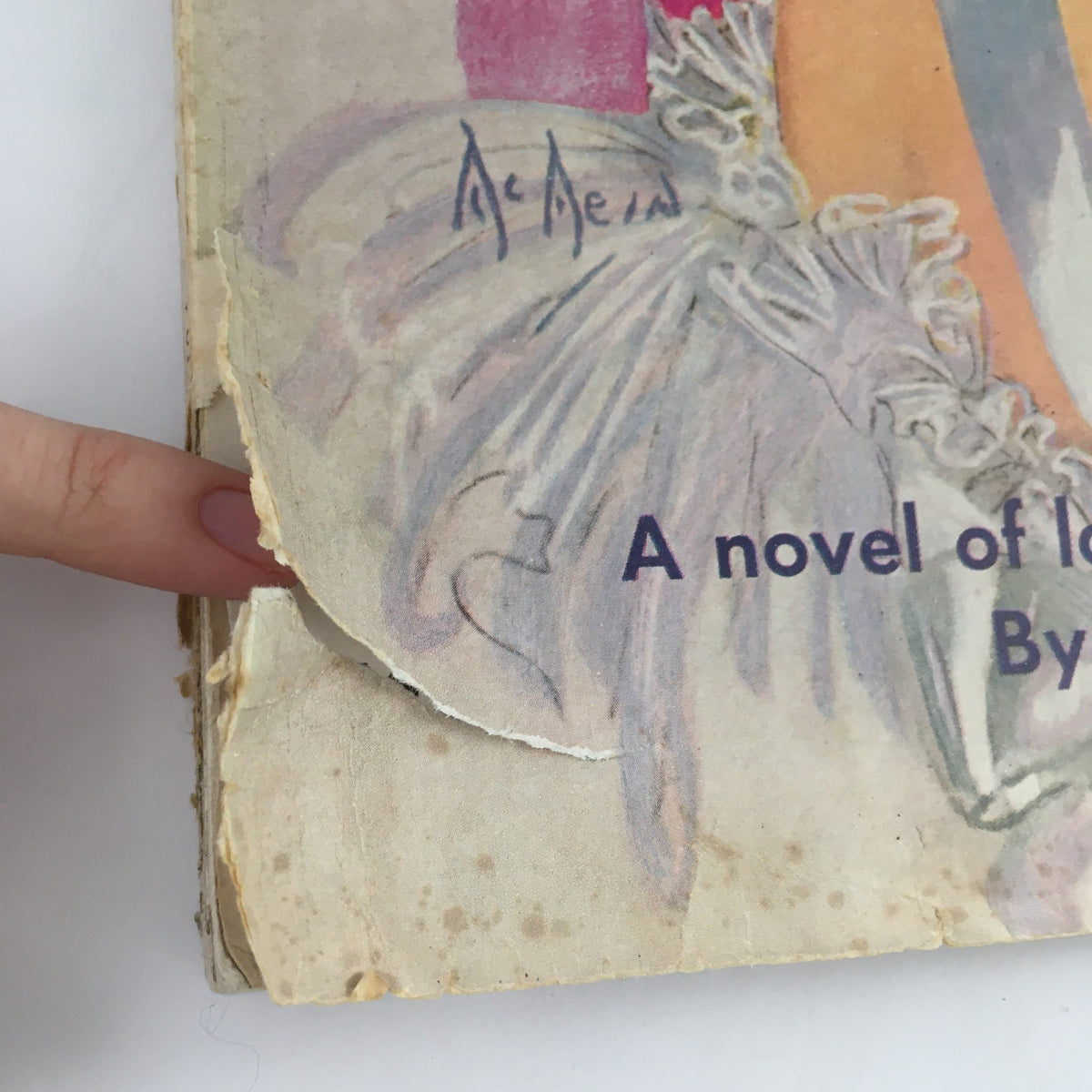 Part of the cover of McCall's Magazine May 1936 showcasing wear and details of the novel title by Lois Montross.