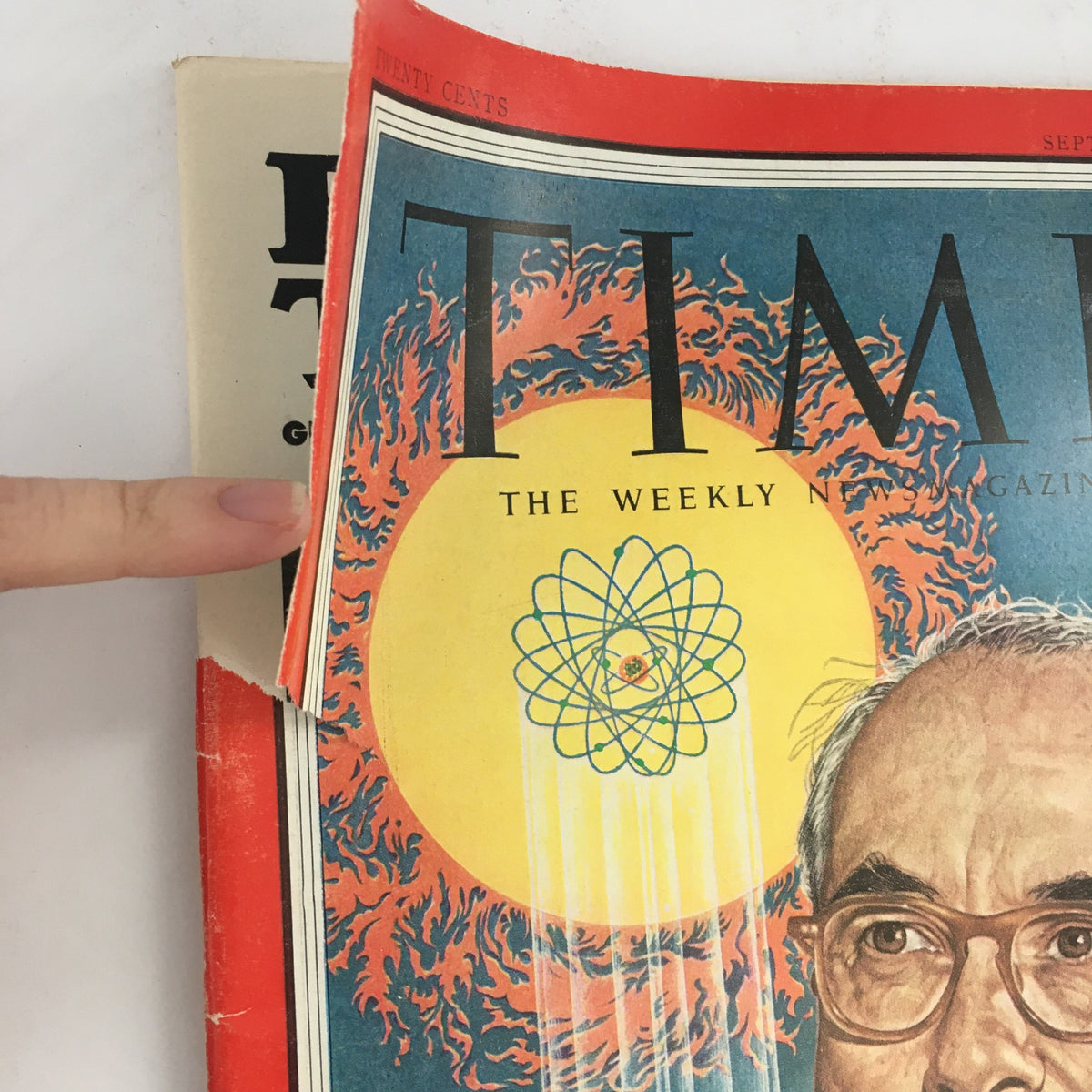 Side view of Time Magazine, September 21, 1953, showcasing the cover featuring U.S. Atom Boss Lewis Strauss and atomic symbol imagery.