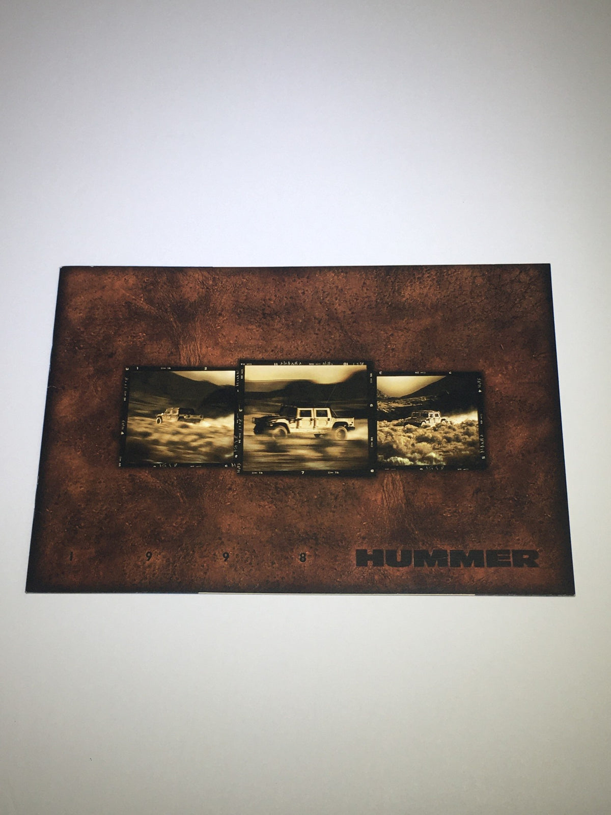 Front cover of the 1998 Hummer 4x4 Dealership Car Auto Brochure Catalog featuring three images of Hummer vehicles.