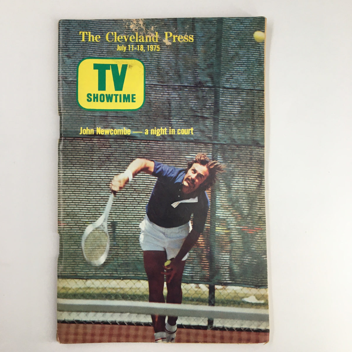 Cover of The Cleveland Press TV Showtime Guide dated July 11-18, 1975, featuring John Newcombe in action on the tennis court.