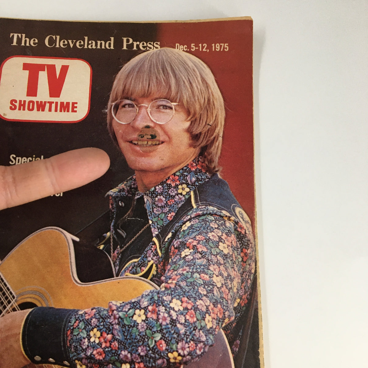 Close-up of the cover of The Cleveland Press TV Showtime Guide December 5 1975, highlighting John Denver with a floral shirt and glasses, promoting his special songs.