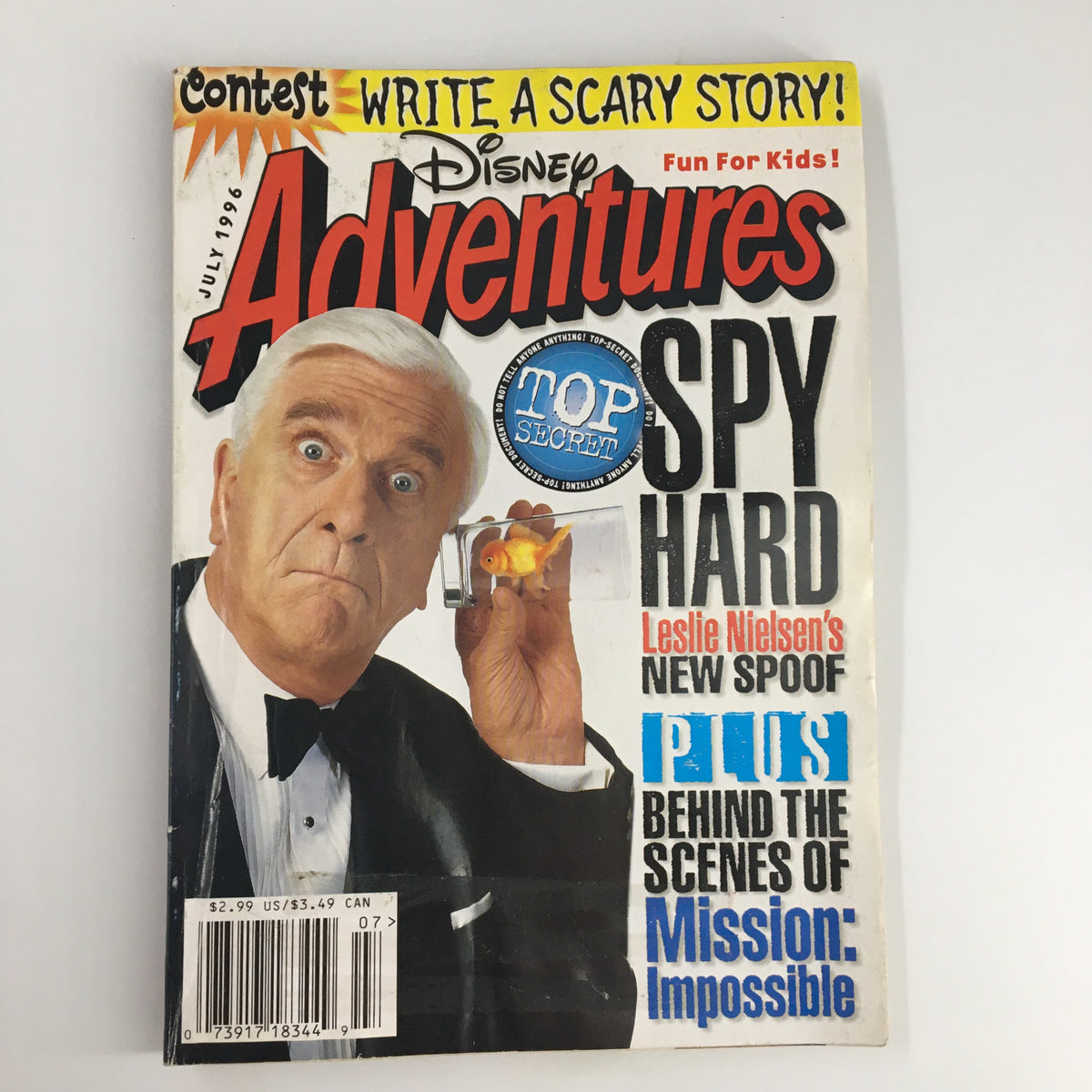 Disney Adventures Magazine July 1996 featuring Leslie Nielsen in a tuxedo, promoting the movie Spy Hard, with a goldfish in hand and the text 'TOP SECRET' highlighted.