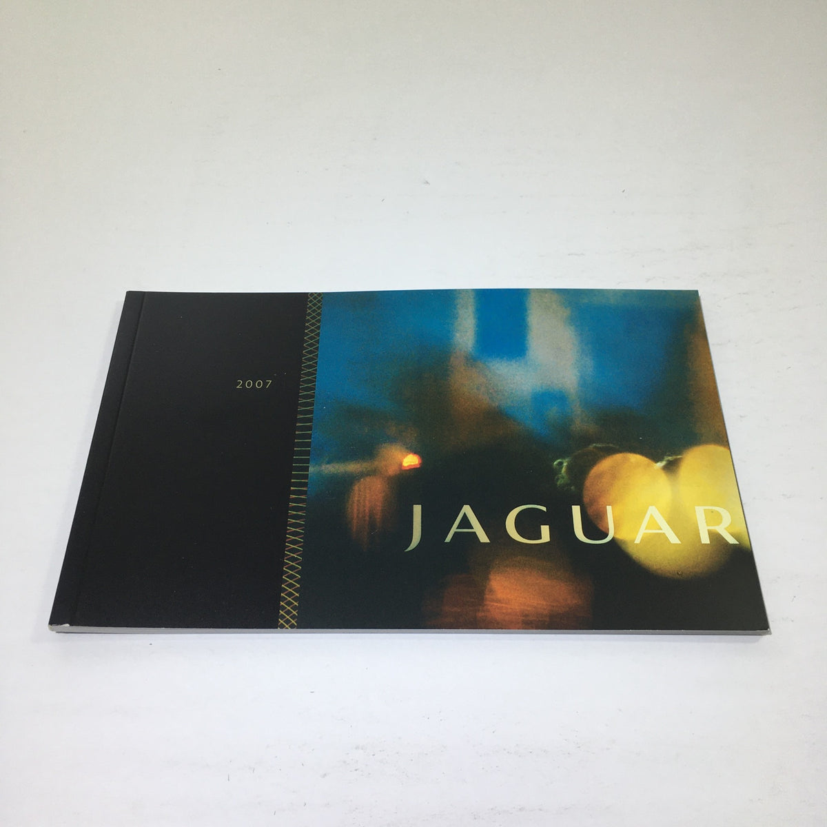 2007 Jaguar R Performance PG 28 Dealership Car Auto Brochure Catalog showcasing a sleek cover with blurred lights, emphasizing elegance and automotive excellence.