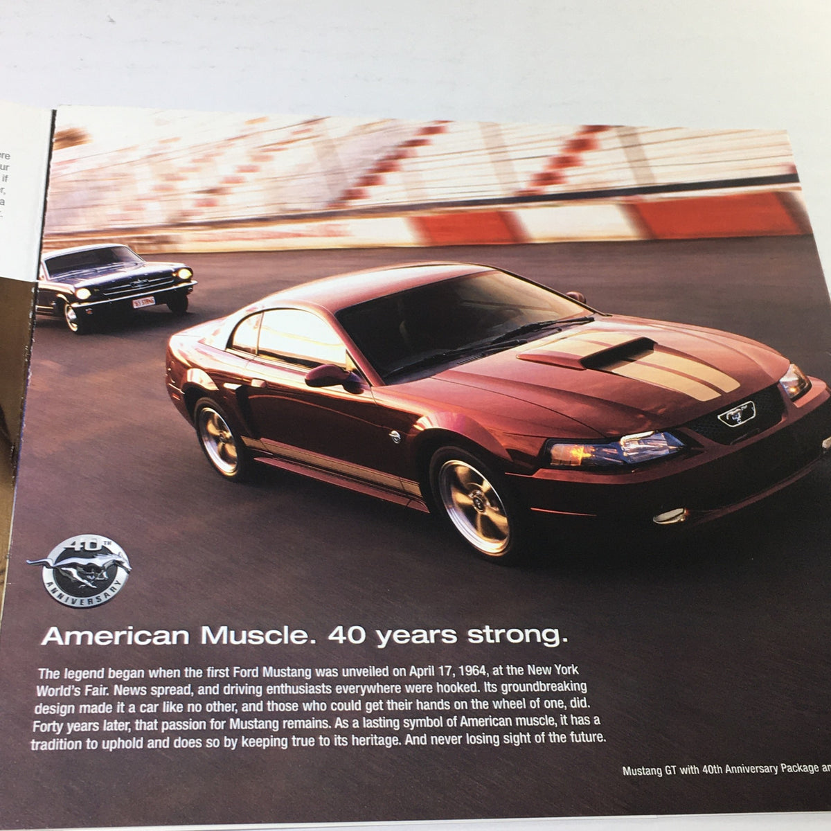 2004 Ford Mustang Muscle Chuck McCrickard Dealership Car Auto Brochure Catalog image featuring a red Mustang GT on a racetrack, highlighting the theme 'American Muscle. 40 years strong'.