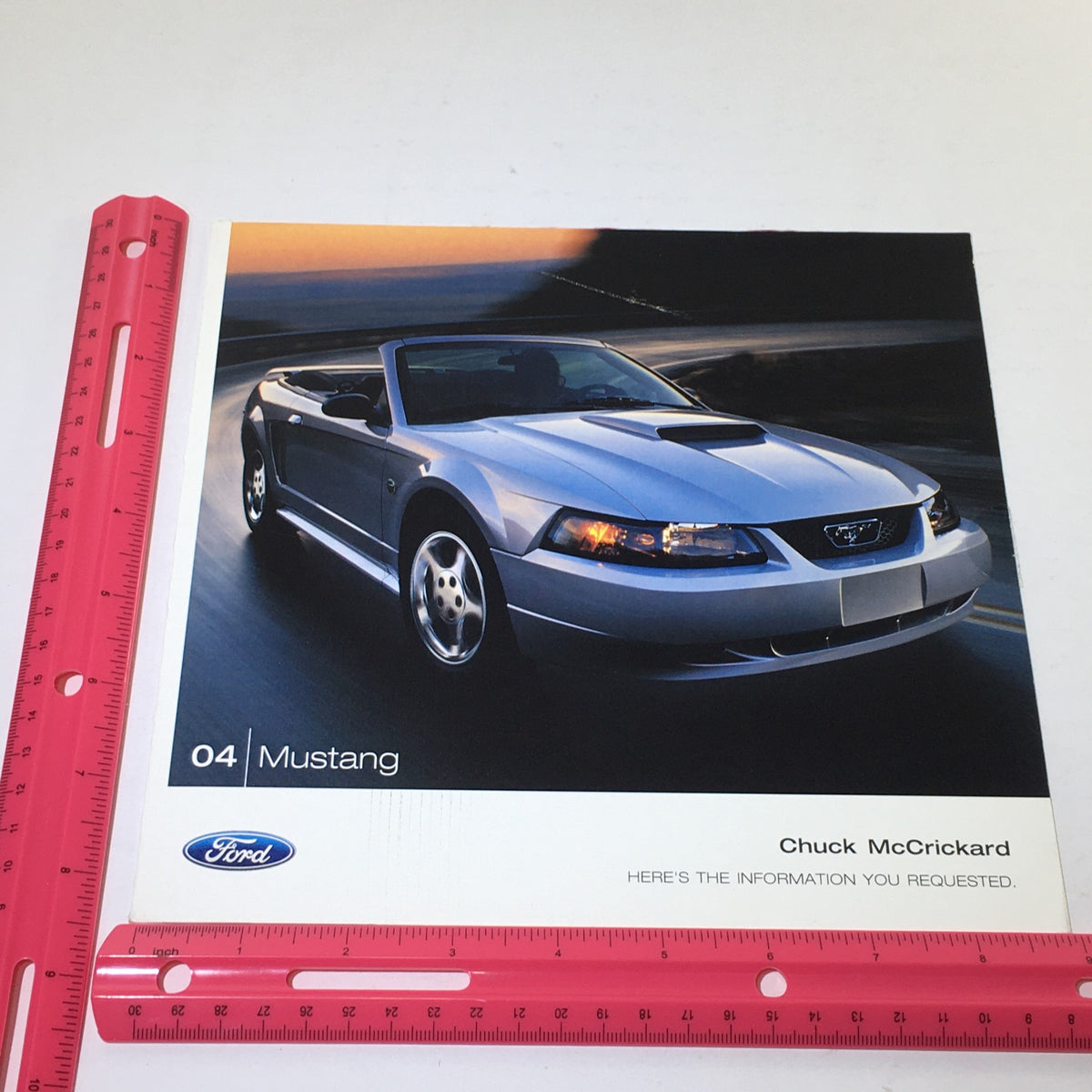 Front cover of the 2004 Ford Mustang Muscle Chuck McCrickard Dealership Car Auto Brochure Catalog showcasing the Mustang convertible model in a sunset backdrop.