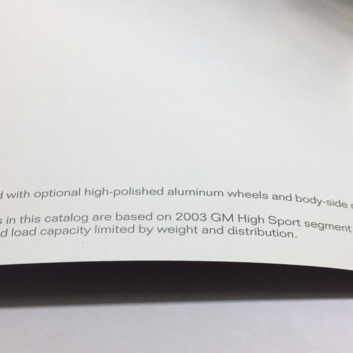 Inside view of the 2004 Chevrolet Corvette Dealership Car Auto Brochure highlighting details about high-polished aluminum wheels and specifications.