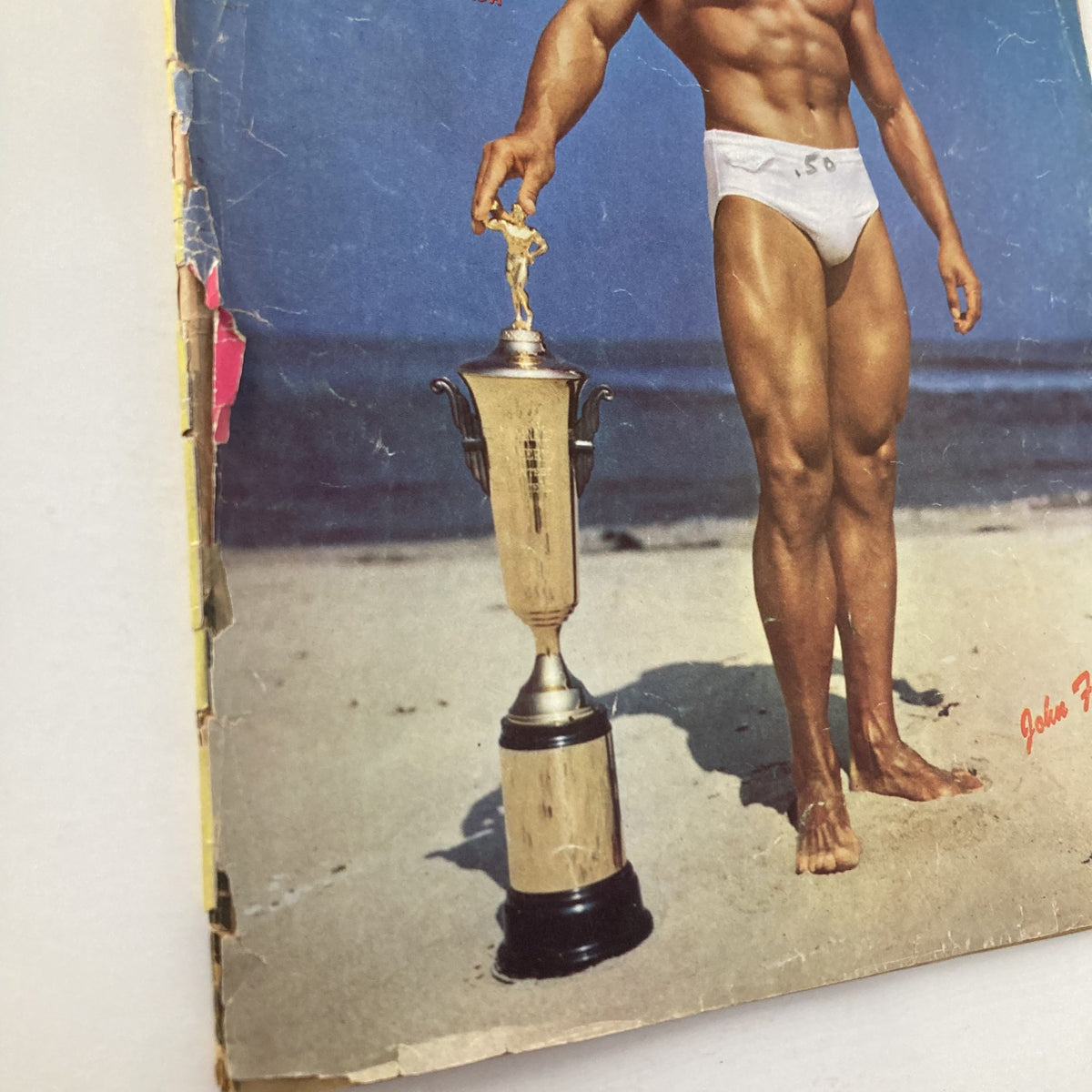 Cover of VTG Strength & Health Magazine December 1951 featuring a muscular man holding a trophy, designed by John Farbotnik.