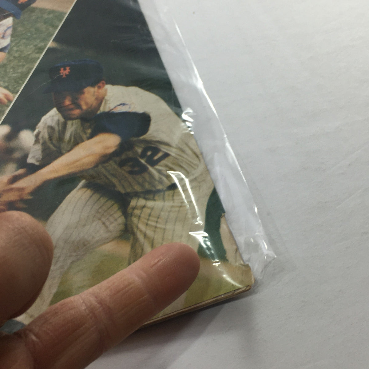 Close-up view of the 1977 New York Mets Official Program, highlighting a player in action with a focus on the program's edges, indicative of its condition.