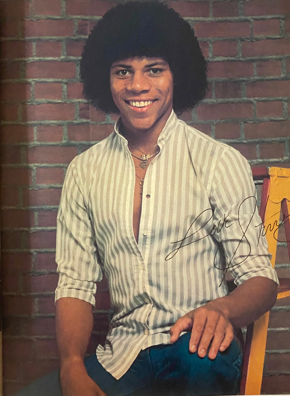 A young male model featured in Tiger Beat Magazine February 1981, posed smiling against a brick backdrop in a stylish outfit.