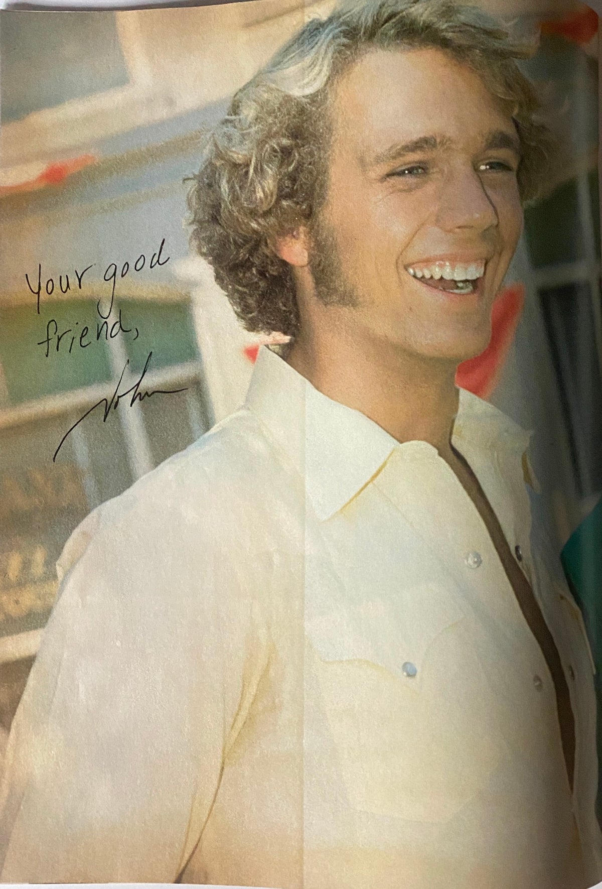 Vibrant photo of a smiling male star dressed in a light-colored shirt, originally printed in the December 1980 issue of Tiger Beat Magazine.