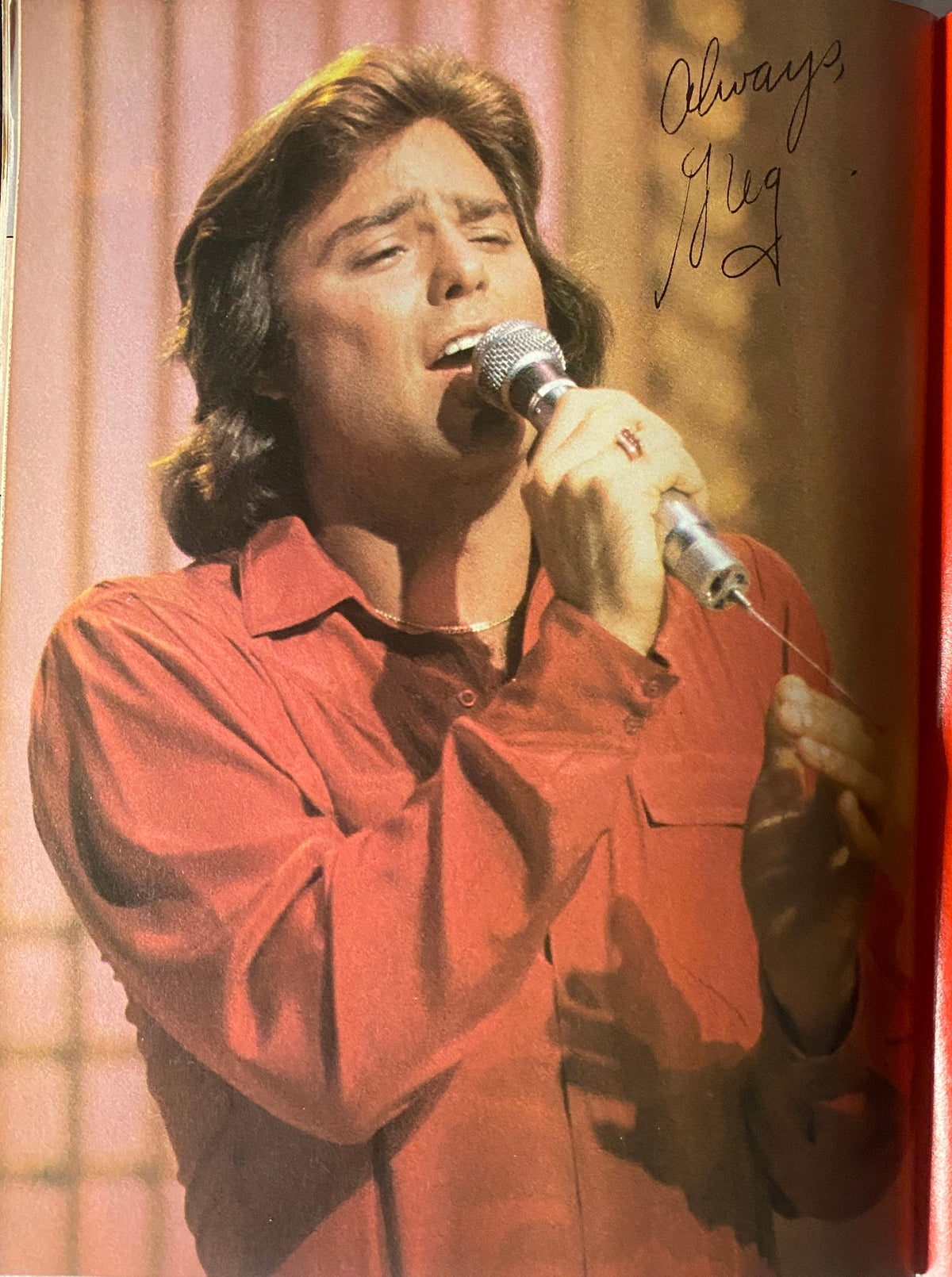 Vintage photograph of a male singer performing with a microphone, featured in the Tiger Beat Magazine December 1980 issue with Matt Dillon and Chris Atkins.