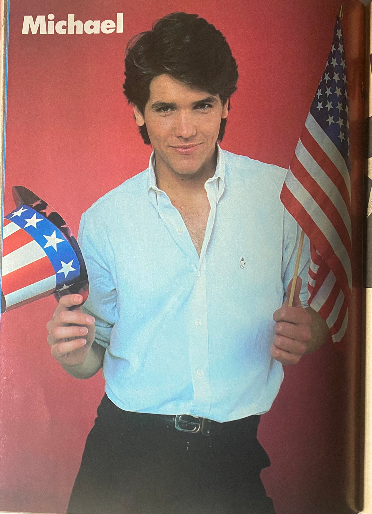 Michael with American flag and top hat in a vintage photo from Tiger Beat Star Magazine August 1982, highlighting the nostalgic style of the era.