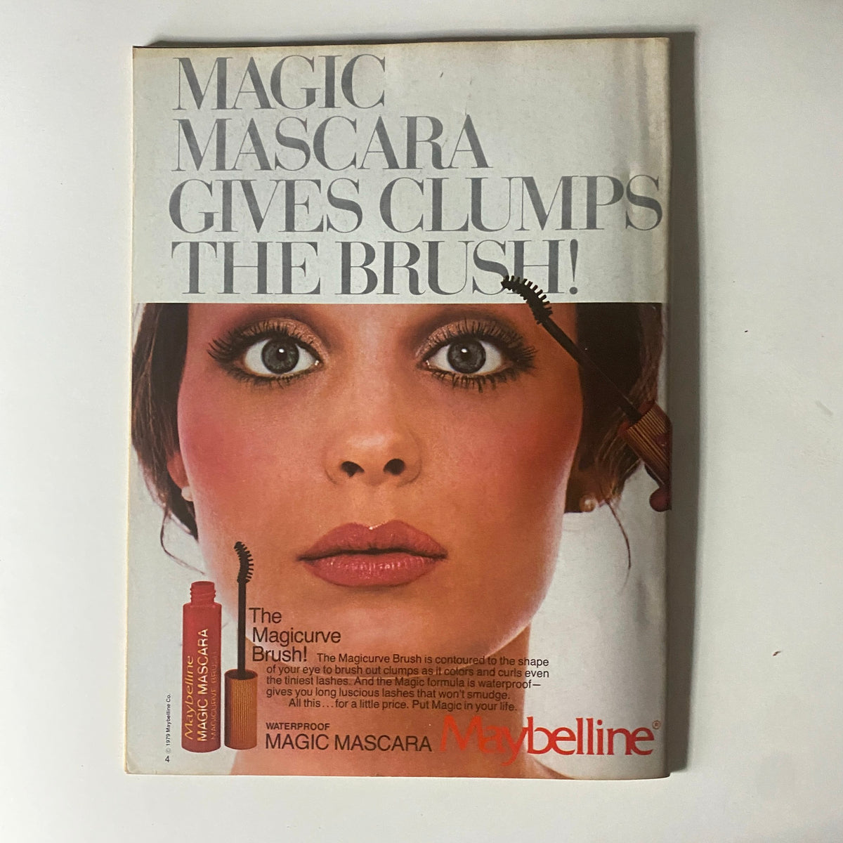 Vintage advertisement for Maybelline Magic Mascara highlighting a glamorous model, representing beauty trends of the 1980s.