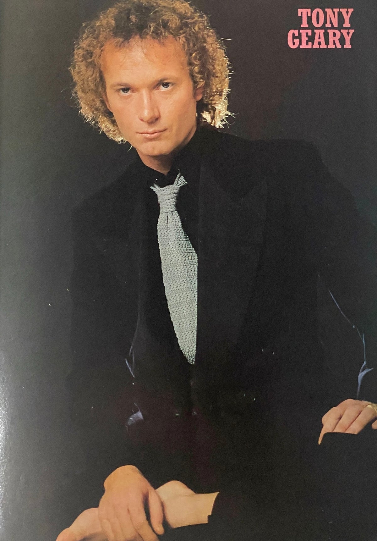 Tony Geary featured in Tiger Beat Star Magazine August 1981, dressed in a black suit with a knitted tie, exuding a classic 1980s vibe.